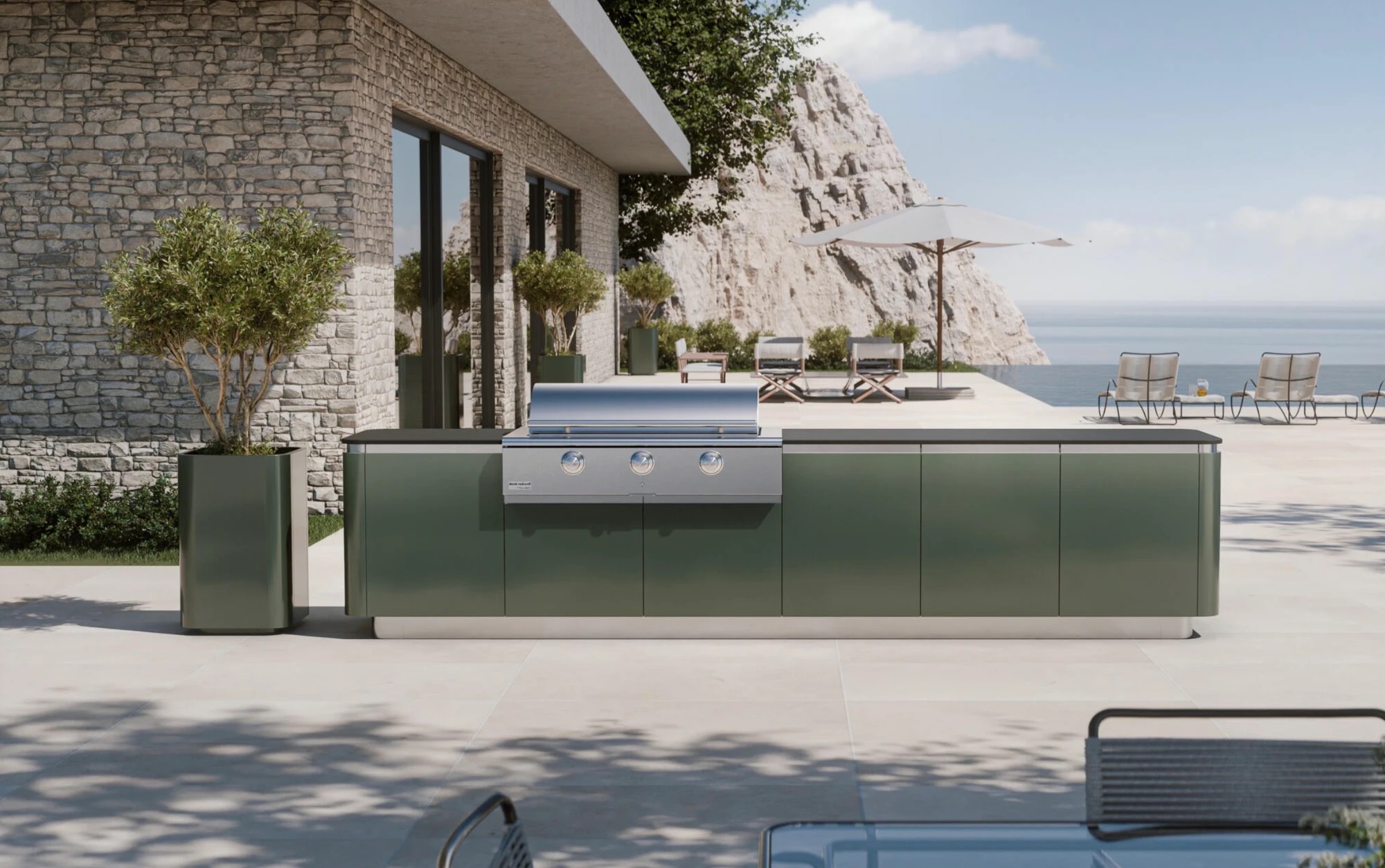 Brown Jordan Ascento outdoor kitchen in ChromicaFeroe green with a stainless grill on a seaside stone terrace