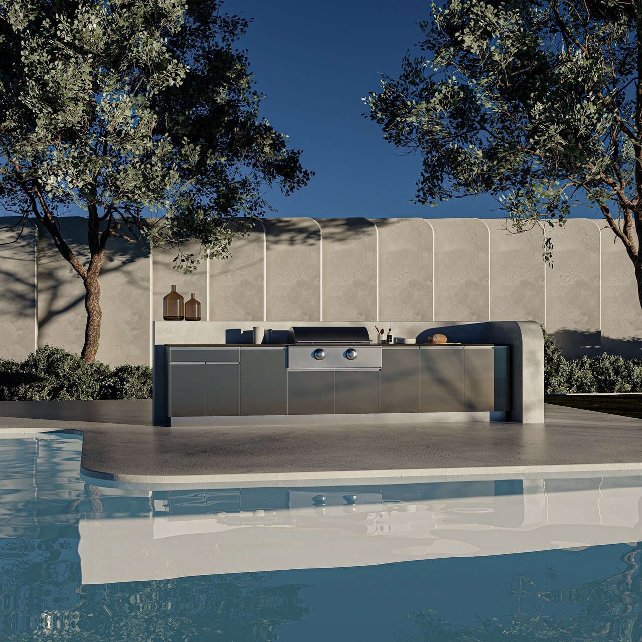Graphite outdoor kitchen beside a pool at dusk